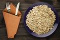 Oatmeal on a wooden table. Oatmeal top view. Healthy food