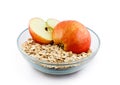 Oats and apple halves in transparent bowl