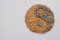 Oats grain and dried lavender flowers, forming Yin Yang on white background. Natural herbal medicines are used to treat anxiety an