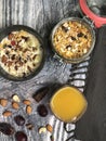 Superfoods smoothies bowls topped with banana, Corn flakes, almond, granola with orange juice. Royalty Free Stock Photo