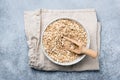 Oats or oat flakes in bowl on linen textile Royalty Free Stock Photo