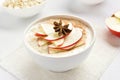 Oats porridge with red apple slices and cinnamon Royalty Free Stock Photo