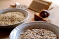 Oats and rice in a bowl. Rice cakes and bread in background. Foods high in carbohydrate. Royalty Free Stock Photo
