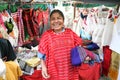 Mexican woman selling traditional mexican shawl and clothes in