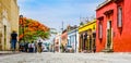 Oaxaca, Mexico on 24th April 2016: Street with Colorful colonial buildings in th eold town with a group of people Royalty Free Stock Photo