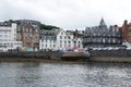 Oban, United Kingdom - February 20, 2010: bay with houses on grey sky. City architecture along sea quay. Resort town