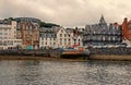 Oban, United Kingdom - February 20, 2010: bay with houses on grey sky. City architecture along sea quay. Resort town