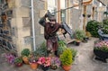 Oban, United Kingdom - February 20, 2010: warrior statue on building corner with pot plants. Town house with bench and