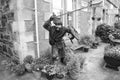 Oban, United Kingdom - February 20, 2010: warrior statue on building corner with pot plants. Town house with bench and