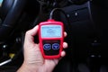 OBD2 or OBD scanner in a auto mechanic hand for engine system analysis Royalty Free Stock Photo