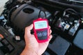 OBD2 or OBD scanner in a auto mechanic hand for engine system analysis Royalty Free Stock Photo