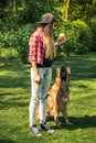 Obedience dog training session in home garden Royalty Free Stock Photo