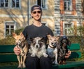 Obedient dogs with trainer and  owner sitting on a bank Royalty Free Stock Photo