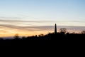 The Obelisk at Eastnor, Herefordshire silhouetted against the sunset on a winters afternoon. UK Royalty Free Stock Photo