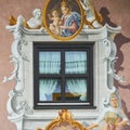 Close-up of a window decorated with paintings on a traditional Bavarian house