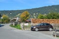 OBERAMMERGAU, GERMANY - OKTOBER 09, 2018: Car and pile of firewood besides of a village house in the Alps in autumn