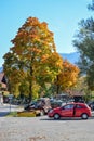 OBERAMMERGAU, GERMANY - OKTOBER 09, 2018: Car and tractor under a yellow tree in the autumn afternoon in Alps Royalty Free Stock Photo