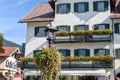 OBERAMMERGAU, GERMANY - OKTOBER 09, 2018: Vintage lantern with flowers on the balcony of old building under sun