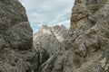 Oberbachernspitze - A sneak-peak on a high and distant mountain in Italian Dolomites. The mountain is visible between two slopes