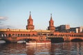 Oberbaumbruecke / Oberbaum Bridge and boat on river Spree in Berlin, Germany