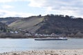 Oberdiebach, Germany - 03 14 2022: Cargo ship passing Burg FÃÂ¼rstenberg