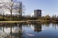 Gasometer Oberhausen behind a lake with asian koi fish