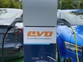 Closeup of evo loading pole station charging two electric cars focus on center