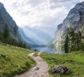 Obersee lake in the middle of coniferous forest between rocky walls at sunset. View of a mountain lake between fir trees