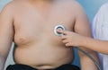 Obese asian boy check heart by stethoscope