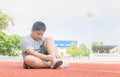 Obese boy tying shoe laces prepare to run Royalty Free Stock Photo