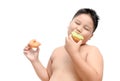 Obese fat boy is eating donut isolated