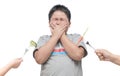 Obese fat boy with expression of disgust against vegetables Royalty Free Stock Photo