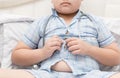 Obese fat boy overweight. Tight shirt of pajamas Royalty Free Stock Photo