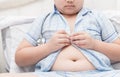 Obese fat boy overweight. Tight shirt of pajamas Royalty Free Stock Photo