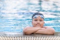 Obese fat boy wear goggle and smile in swimming pool