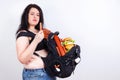 Obese fat woman with a great backpack full of junk food on her b Royalty Free Stock Photo