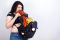 Obese fat young woman with a great backpack full of junk food on Royalty Free Stock Photo