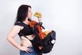 Obese fat young woman with a great backpack full of junk food on Royalty Free Stock Photo