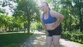 Obese girl jogging, suffocating, feels belly pain after tiresome workouts