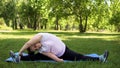 Obese girl practicing yoga, weight loss program, unity with nature, harmony