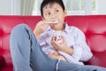 Obese little boy eating tasty ice cream at home