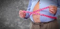 Obese man abdomen with measuring tape.