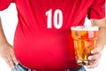 Obese man with big belly holding a glass of refreshing cold beer Royalty Free Stock Photo