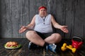 Obese man can not decide whether to train or eat