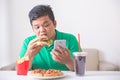 Obese man eating junk food Royalty Free Stock Photo