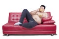 Obese man eats two hamburger on sofa Royalty Free Stock Photo