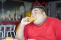 Obese man enjoying crunchy fried chicken