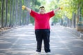 Obese man exercising with dumbbells in the park Royalty Free Stock Photo