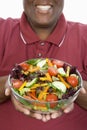 An Obese Man Holding Bowl Of Salad
