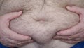Obese Man Showing His Fat Belly, a Hungry Person Measuring His Belly Fat